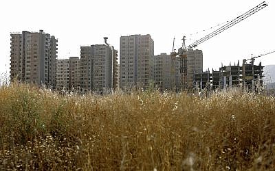 This July 6, 2019, photo shows residential towers in District 22 that consists of apartment high-rises and shopping malls arranged around an artificial lake called Chitgar, under construction on the northwestern edge of Tehran, Iran (AP Photo/Ebrahim Noroozi)