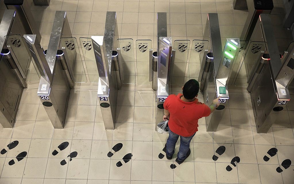 A Palestinian man uses a biometric gate as he crosses into Israel at the Qalandiya crossing in Jerusalem, July 11, 2019. (Sebastian Scheiner/AP) A Palestinian man uses a biometric gate as he crosses into Israel at the Qalandiya crossing in Jerusalem, July 11, 2019. (Sebastian Scheiner/AP)