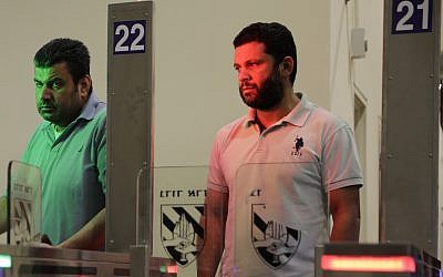 Palestinians stand in front of a biometric gate as they enter Israel at the Qalandiya crossing in Jerusalem, July 11, 2019. (Sebastian Scheiner/AP)