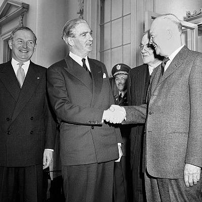 US president Dwight Eisenhower and British prime ,inister Anthony Eden shake hands as they stand on the North Portico of the White House on January 30, 1956. (AP Photo)