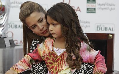 Princess Haya Bint Al Hussein holds her daughter Al Jalilah in her lap during the award ceremony of Dubai Ladies Masters golf tournament in Dubai, United Arab Emirates, Saturday Dec. 8, 2012. (AP Photo/Kamran Jebreili)