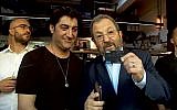 Screen capture from video of Israel Democratic Party leader Ehud Barak, right, demonstrating how to use a credit card. (Twitter)