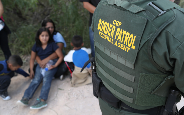 Central American asylum seekers wait as US Border Patrol agents take them into custody near McAllen, Texas, June 12, 2018. (John Moore/Getty Images/via JTA) Central American asylum seekers wait as US Border Patrol agents take them into custody near McAllen, Texas, June 12, 2018. (John Moore/Getty Images/via JTA)