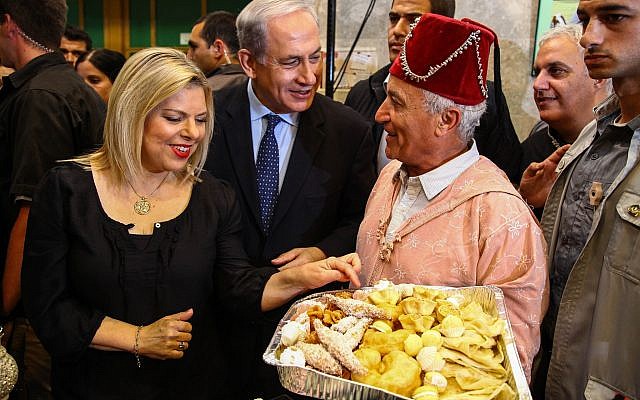 Prime Minister Benjamin Netanyahu and his wife Sara attend a Moroccan Jewish Mimuna celebration in Or Akiva on April 21, 2014. (Avishag Shaar Yashuv/POOL/FLASH90)