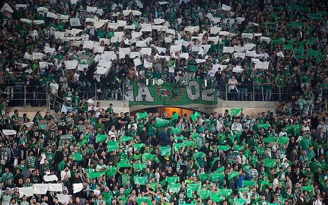 Illustrative: Fans of the Maccabi Haifa soccer team cheer during a game at the Teddy stadium in Jerusalem, May 24, 2016. (Yonatan Sindel/Flash90) Illustrative: Fans of the Maccabi Haifa soccer team cheer during a game at the Teddy stadium in Jerusalem, May 24, 2016. (Yonatan Sindel/Flash90)
