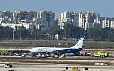Rescuers reach a damaged Boeing 737 plane on the runway at Ben Gurion Airport shortly after it lands safely, despite a blown tire, on July 1, 2019. (Flash90)