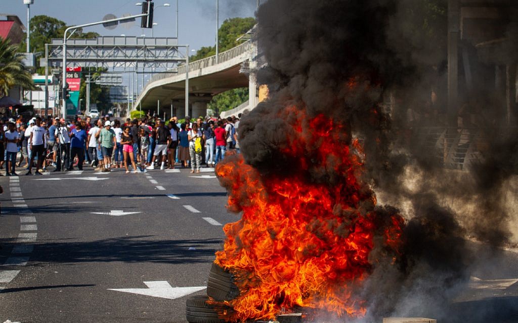 Ethiopian Israelis, family members and activists protest following the death of 19-year-old Ethiopian, Solomon Tekah, who was shot and killed last night in Kiryat Haim by an off-duty police officer, outside Kiryat Ata, July 1, 2019. (Meir Vaknin/Flash90)