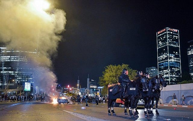 Israeli police officers at a protest following the death of 19-year-old Ethiopian, Solomon Tekah who was shot and killed on June 30 in Haifa by an off-duty police officer, in Tel Aviv, July 2, 2019. (Adam Shuldman/Flash90) Israeli police officers at a protest following the death of 19-year-old Ethiopian, Solomon Tekah who was shot and killed on June 30 in Haifa by an off-duty police officer, in Tel Aviv, July 2, 2019. (Adam Shuldman/Flash90)