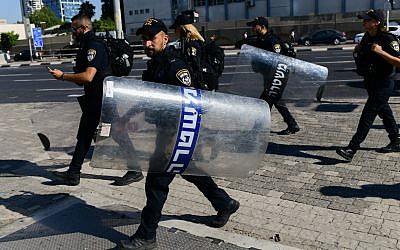 Israeli police officers at a protest following the shooting death of 19-year-old Ethiopian-Israeli Solomon Tekah, in Tel Aviv, July 3, 2019. (Tomer Neuberg/Flash90)