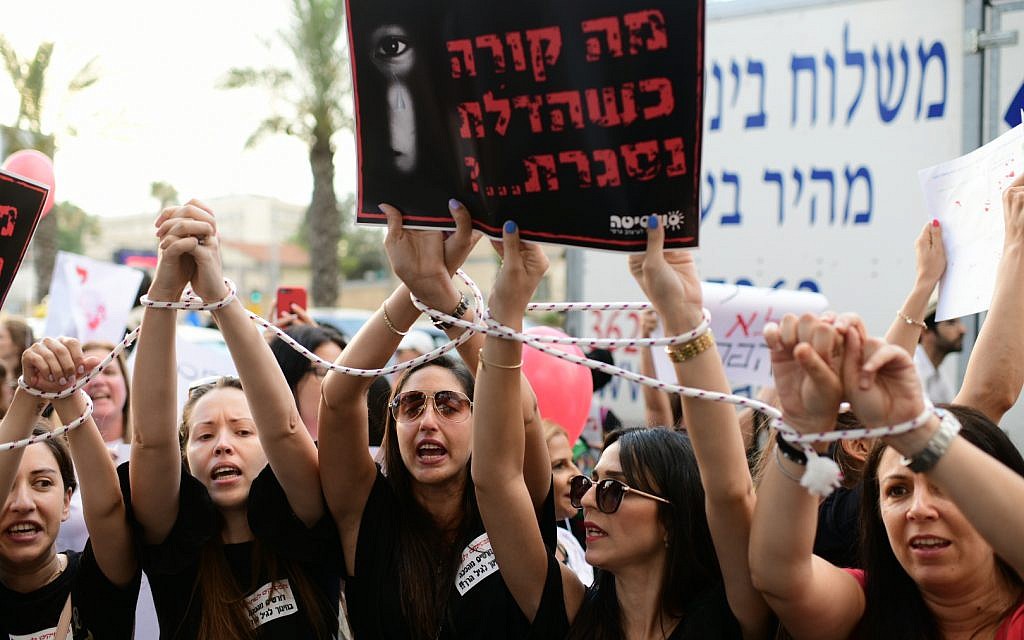 Parents protest against the abuse of children in private daycare centers in Tel Aviv on July 7, 2019. The sign reads 'What happens when the door is closed?' (Tomer Neuberg/Flash90) Parents protest against the abuse of children in private daycare centers in Tel Aviv on July 7, 2019. The sign reads 'What happens when the door is closed?' (Tomer Neuberg/Flash90)