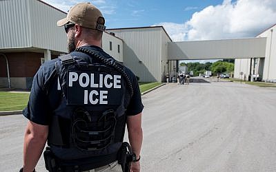 An Immigration and Customs Enforcement special agent prepares to arrest alleged undocumented immigrants in Salem, Mass., June 19, 2018. (Smith Collection/Gado/Getty Images via JTA)