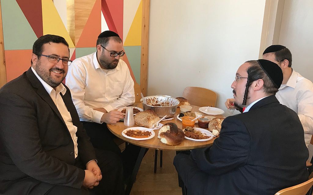 KamaTech's Moshe Friedman, left, partaking in happy hour at the Ampersand Haredi co-working space in Bnei Brak, July 4, 2019 (Shoshanna Solomon/Times of Israel) KamaTech's Moshe Friedman, left, partaking in happy hour at the Ampersand Haredi co-working space in Bnei Brak, July 4, 2019 (Shoshanna Solomon/Times of Israel)