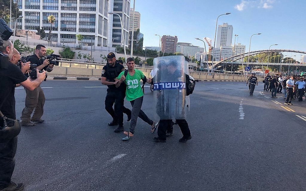 A Meretz party activist is detained by police at a protest by the Ethiopian-Israeli community in Tel Aviv, July 3, 2019. (Naomi Lanzkron)