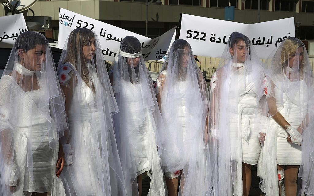 A protest in Lebanon against a law absolving a rapist if he marries his victim. (AP Photo/Hassan Ammar)