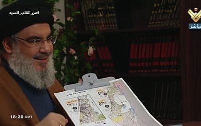Hezbollah leader Sheikh Hassan Nasrallah points to a map of Israel, and specifies potential targets, in a July 12, 2019, TV interview. (Channel 13 screenshot)