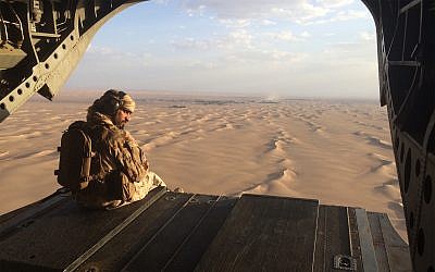 An Emirati gunner watches for enemy fire from the rear gate of a United Arab Emirates Chinook military helicopter flying over Yemen, September 17, 2015. (AP Photo/Adam Schreck, File)