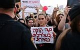Parents protest in Tel Aviv against the abuse of children and infants in kindergartens in Israel, July 7, 2019. The sign reads "What happens when the door closes?" (Tomer Neuberg/ Flash90)
