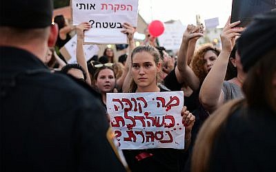 Parents protest in Tel Aviv against the abuse of children and infants in kindergartens in Israel, July 7, 2019. The sign reads "What happens when the door closes?" (Tomer Neuberg/ Flash90)