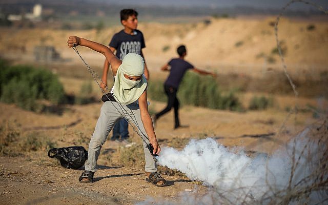 Palestinians rioters clash with Israeli forces on the border near Gaza City, July 26, 2019. (Hassan Jedi/Flash90) Palestinians rioters clash with Israeli forces on the border near Gaza City, July 26, 2019. (Hassan Jedi/Flash90)