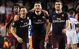 Arsenal defender Sead Kolasinac, center, celebrates with Arsenal midfielder Mesut Ozil, left, and Arsenal defender Sokratis Papastathopoulos at the end of the Europa League semifinal soccer match between Valencia and Arsenal in Valencia, Spain, May 9, 2019. (AP Photo/Alberto Saiz)