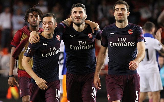Arsenal defender Sead Kolasinac, center, celebrates with Arsenal midfielder Mesut Ozil, left, and Arsenal defender Sokratis Papastathopoulos at the end of the Europa League semifinal soccer match between Valencia and Arsenal in Valencia, Spain, May 9, 2019. (AP Photo/Alberto Saiz) Arsenal defender Sead Kolasinac, center, celebrates with Arsenal midfielder Mesut Ozil, left, and Arsenal defender Sokratis Papastathopoulos at the end of the Europa League semifinal soccer match between Valencia and Arsenal in Valencia, Spain, May 9, 2019. (AP Photo/Alberto Saiz)