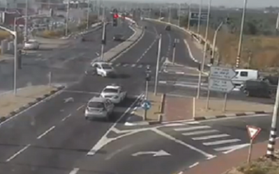 A child tumbles out of a car as it crosses an intersection near Kochav Ya'ir (screenshot)