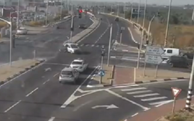 A child tumbles out of a car as it crosses an intersection near Kochav Ya'ir (screenshot) A child tumbles out of a car as it crosses an intersection near Kochav Ya'ir (screenshot)