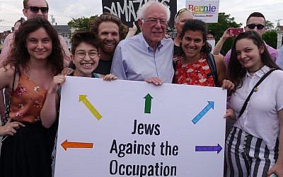 Illustrative: Vermont Senator Bernie Sanders poses with IfNotNow activists in New Hampshire, including University of Michigan student Becca Lubow on the far left, and holds a sign that reads 'Jews Against Occupation.' (Courtesy/IfNotNow)