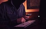 Illustrative image of a computer hacker using a smartphone. (stevanovicigor; iStock by Getty Images)