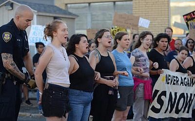 Members of the group Never Again Action are arrested protesting migrant detention policies in Boston on July 2, 2019. (Gili Getz via JTA)