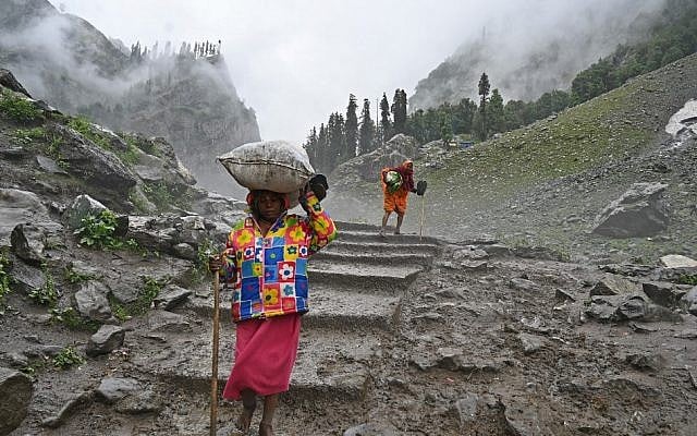 Indian Hindu pilgrims carry bags on their head as they trek up to Chandanwari in Kashmir, some 115 km southeast of Srinagar, during the annual Hindu pilgrimage on July 27, 2019 to the holy cave shrine of Amarnath. (TAUSEEF MUSTAFA / AFP) Indian Hindu pilgrims carry bags on their head as they trek up to Chandanwari in Kashmir, some 115 km southeast of Srinagar, during the annual Hindu pilgrimage on July 27, 2019 to the holy cave shrine of Amarnath. (TAUSEEF MUSTAFA / AFP)