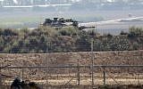 A picture taken from Khan Younis in the southern Gaza Strip shows an Israeli tank near the border fence with the coastal enclave on August 1, 2019, following a firefight with a Palestinian gunman. (Said Khatib/AFP)