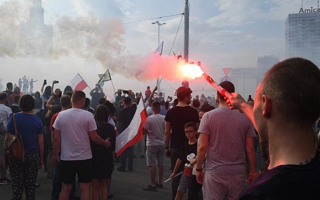 People light flares as they observe a minute of silence to mark the 75th anniversary of the Warsaw Uprising against the Nazi German occupiers during World War II on August 1, 2019, in the Polish capital Warsaw. (Janek Skarzynski/AFP) People light flares as they observe a minute of silence to mark the 75th anniversary of the Warsaw Uprising against the Nazi German occupiers during World War II on August 1, 2019, in the Polish capital Warsaw. (Janek Skarzynski/AFP)