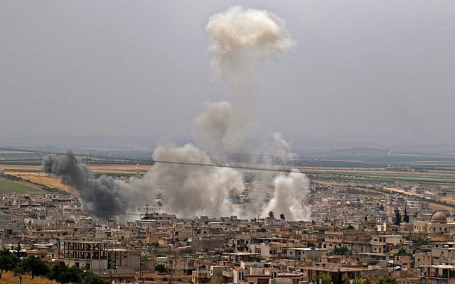 This file photo taken on May 23, 2019 shows smoke rising following reported Syrian government bombardment on the town of Khan Sheikhoun in the southern countryside of the rebel-held Idlib province. (Anas Al-Dyab/AFP)