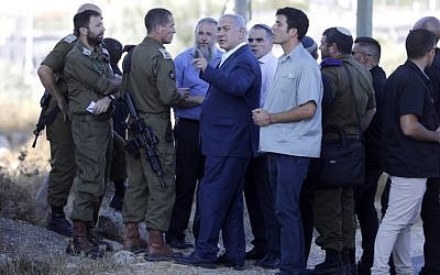 Israel's Prime Minister Benjamin Netanyahu inspects the site where an off-duty Israeli soldier was found dead with stab wounds near the settlement of Migdal Oz in the  West Bank on August 8, 2019. (MENAHEM KAHANA / AFP)