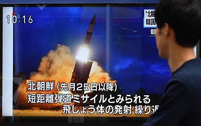 A pedestrian looks at a roadside television screen reporting on North Korea's projectile launch earlier in the day, in Tokyo on August 16, 2019. (Kazuhiro NOGI / AFP)