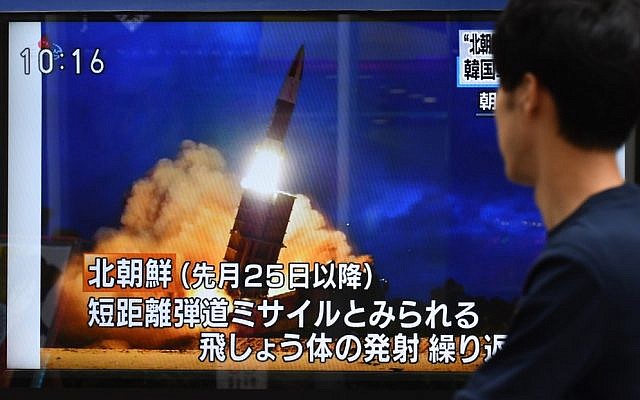 A pedestrian looks at a roadside television screen reporting on North Korea's projectile launch earlier in the day, in Tokyo on August 16, 2019. (Kazuhiro NOGI / AFP) A pedestrian looks at a roadside television screen reporting on North Korea's projectile launch earlier in the day, in Tokyo on August 16, 2019. (Kazuhiro NOGI / AFP)