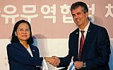 South Korean Trade Minister Yoo Myung-hee (L) and Israeli Economy and Industry Minister Eli Cohen stand after signing a free-trade agreement between Israel and the Republic of Korea in Jerusalem on August 21, 2019.  (Photo by Gil COHEN-MAGEN / AFP)