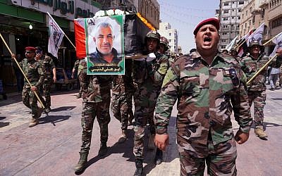 Members of Iraq's Popular Mobilization Forces carry the coffin of their comrade Kazem Mohsen, known by his nom de guerre Abu Ali al-Dabi, during his funeral procession in the central Iraqi shrine city of Najaf on August 26, 2019. (Haidar Hamdani/Hashed al-Shaabi Media/AFP)