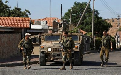 Illustrative: Israeli soldiers patrolling near the northern Israeli town of Avivim, close to the border with Lebanon, August 26, 2019. (Jalaa Marey/AFP)