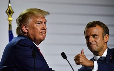 US President Donald Trump, left, and French President Emmanuel Macron gesture during a joint press conference on August 26, 2019, the third day of the annual G7 Summit in Biarritz, south-west France. (Nicholas Kamm /AFP)