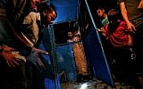 Palestinians look at the destroyed booth of a police checkpoint hit in an explosion in Gaza City on August 27, 2019. (Photo by MAHMUD HAMS / AFP)