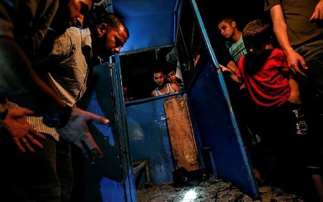 Palestinians look at the destroyed booth of a police checkpoint hit in an explosion in Gaza City on August 27, 2019. (Photo by MAHMUD HAMS / AFP) Palestinians look at the destroyed booth of a police checkpoint hit in an explosion in Gaza City on August 27, 2019. (Photo by MAHMUD HAMS / AFP)