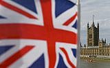The Palace of Westminster housing the Houses of Parliament is seen from Westminster Bridge with a Union Flag in the foreground in central London on August 28, 2019. (Photo by DANIEL LEAL-OLIVAS / AFP)