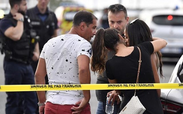 A witness (R) is comforted by friends in Villeurbanne on the outskirts of Lyon, south-eastern France on August 31, 2019, after a knife attack which has left one dead and nine injured. (Photo by PHILIPPE DESMAZES / AFP) A witness (R) is comforted by friends in Villeurbanne on the outskirts of Lyon, south-eastern France on August 31, 2019, after a knife attack which has left one dead and nine injured. (Photo by PHILIPPE DESMAZES / AFP)