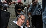 A protest group called Hot Mess holds up posters of Jeffrey Epstein in front of the Federal courthouse in New York City, on July 8, 2019. (Stephanie Keith/Getty Images/AFP)