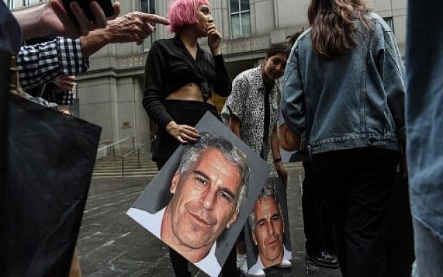 A protest group called Hot Mess holds up posters of Jeffrey Epstein in front of the Federal courthouse in New York City, on July 8, 2019. (Stephanie Keith/Getty Images/AFP) A protest group called Hot Mess holds up posters of Jeffrey Epstein in front of the Federal courthouse in New York City, on July 8, 2019. (Stephanie Keith/Getty Images/AFP)
