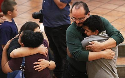 People hug at St Pius X Church at a vigil for victims after a mass shooting that left at least 20 people dead on August 3, 2019, in El Paso, Texas. (Mario Tama/Getty Images/AFP)