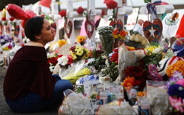 Yamileth Lopez with a photo of her deceased friend Javier Amir Rodriguez at a makeshift memorial for victims of a mass shooting which left at least 22 people dead, on August 6, 2019 in El Paso, Texas. Mario Tama/Getty Images/AFP Yamileth Lopez with a photo of her deceased friend Javier Amir Rodriguez at a makeshift memorial for victims of a mass shooting which left at least 22 people dead, on August 6, 2019 in El Paso, Texas. Mario Tama/Getty Images/AFP