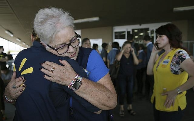 Walmart employees comfort one another after a shooter opened fire at a store in El Paso, Texas, Saturday, Aug. 3, 2019. (Mark Lambie/The El Paso Times via AP) Walmart employees comfort one another after a shooter opened fire at a store in El Paso, Texas, Saturday, Aug. 3, 2019. (Mark Lambie/The El Paso Times via AP)